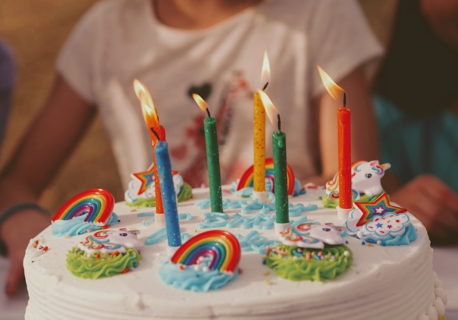 Birthday cake decorated with colourful candles and rainbow toppers