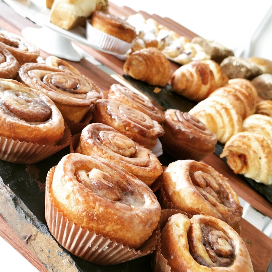 Assorted pastries, cinnamon rolls and croissants on a wooden board